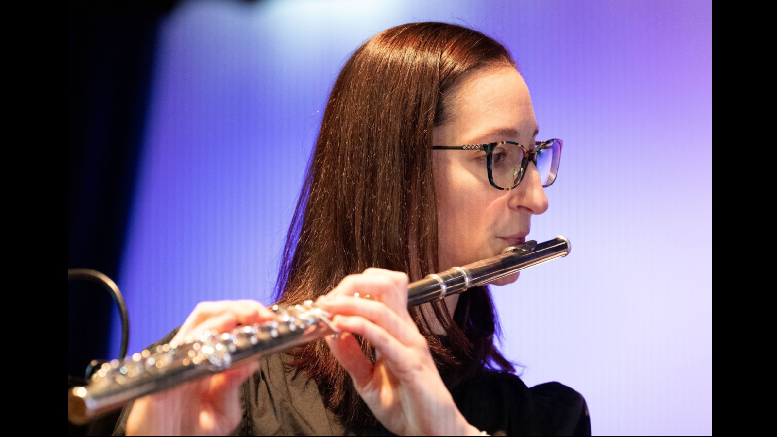 close up photograph of a woman playing Flute